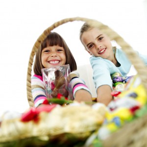 Two Young Girls Sitting with a Basketful of Candy
