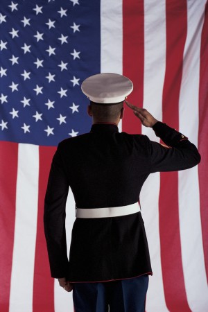 Man in U.s. Marine Corps Uniform Saluting American Flag