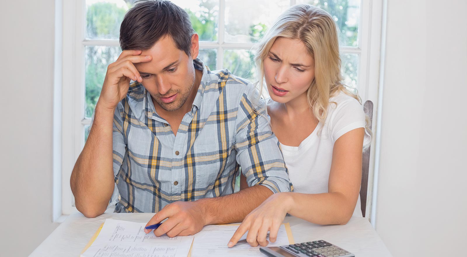 Advice for First Time Home Buyers - couple reviewing finances