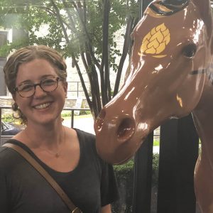 Erin Oxender posing with plastic horse.