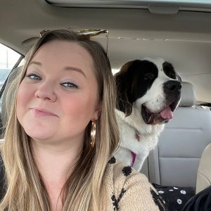 Courtney Weber in a car with dog