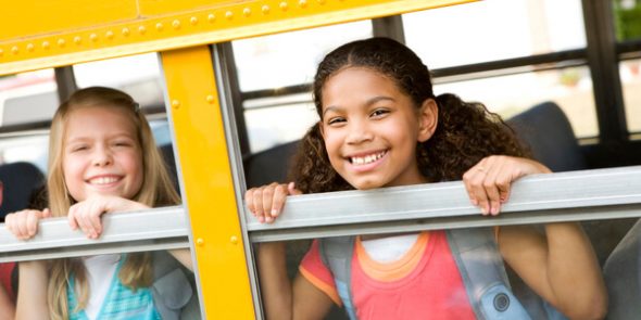 children in school bus window