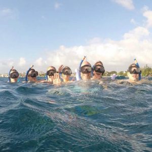 Jeanne Okeefe snorkeling with group of people.