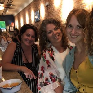 Stefanie Halbert with women at a bar.