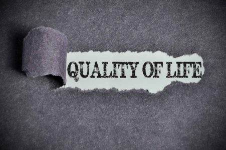 quality of life word under torn black sugar paper